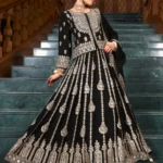 Black Embroidered Choli Lehenga Set: A woman posing in a premium 3-piece festive outfit featuring a heavily embroidered choli, a flared black lehenga with intricate silver Zari work, and a matching dupatta.