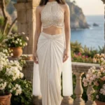 Off-White Net Drape Skirt Set with a Hand-embroidered Halter Neck Blouse, featuring Intricate Beadwork and Sequin Embellishments for a Luxury Indo-Western Style look.