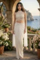 Off-White Net Drape Skirt Set with a Hand-embroidered Halter Neck Blouse, featuring Intricate Beadwork and Sequin Embellishments for a Luxury Indo-Western Style look.