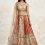 Ivory digital printed Chanderi lehenga with mirror work and beadwork fringe for bridesmaid sangeet look by Sysha.