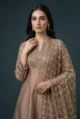 Close-up of the scalloped sleeves with decorative mirror hangings on the silk Anarkali