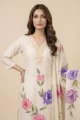 Close-up view of the delicate gold lace embroidery on the V-neckline of the white mull cotton kurta.