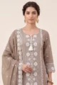 Detailed view of the intricate scalloped lace borders on the hemline and 3/4th sleeves of the beige rayon tunic.