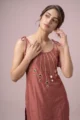 Detailed view of the delicate tie-up shoulder straps and matching thread tassels on the strappy Chanderi tunic.