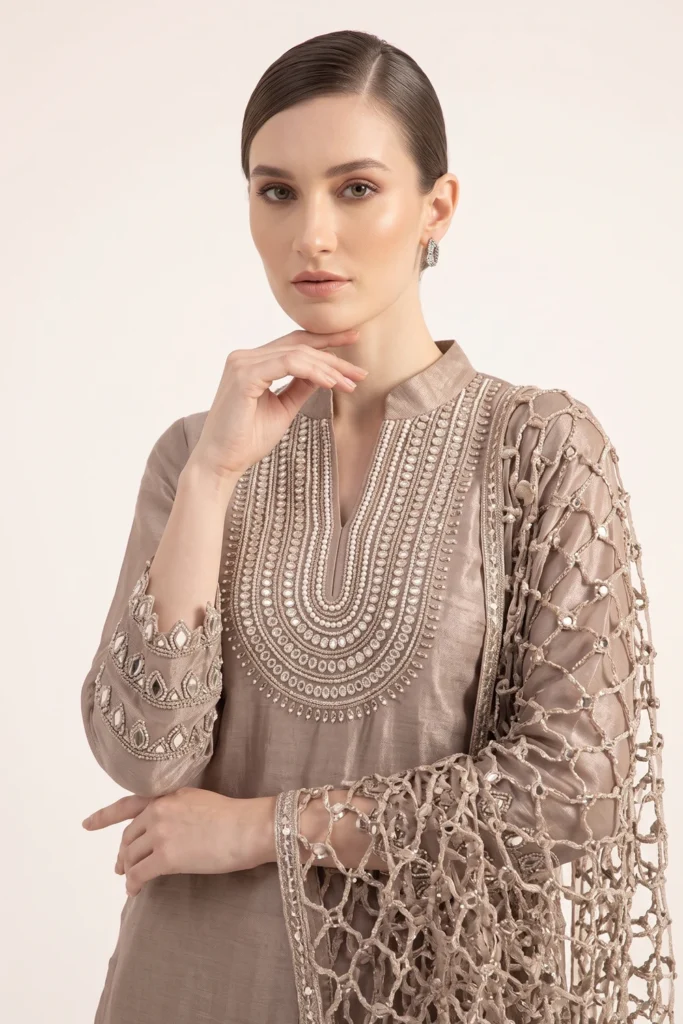 Close-up view of the dense handcrafted beadwork and zardozi embroidery on the V-neck bib of the Mocha Brown tissue silk kurta.