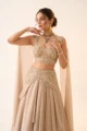Detailed view of the embellished floral waist yoke and asymmetrical draped layers on the chinon skirt.