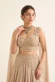 Close-up view of the dense pearl beadwork, cutdana embroidery, and floral motifs on the cream chinon choli.