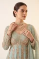 Close-up view of the dense gold zari embroidery, V-neckline, and patterned insets on the sky blue shimmer peplum top.